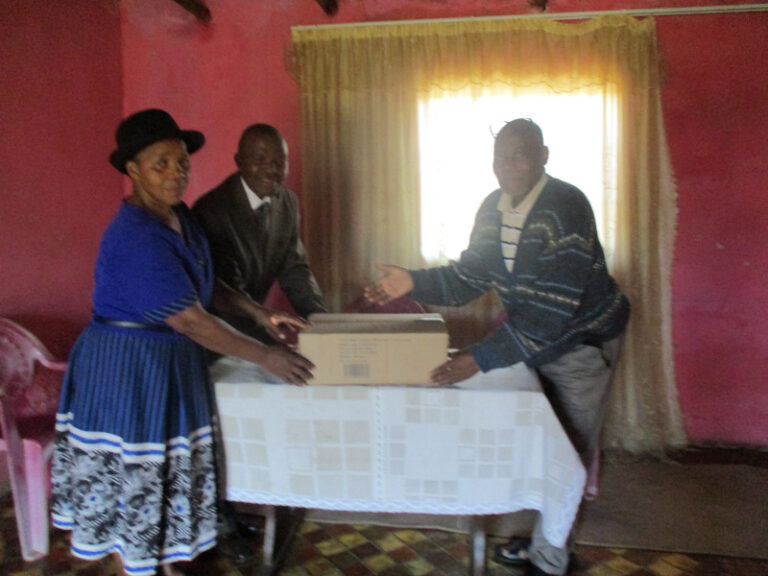 ACAT Extension Co-ordinator, Mandla Manyoni, hands over a box of Bibles to Pastor Ngubane of African Gospel Church.