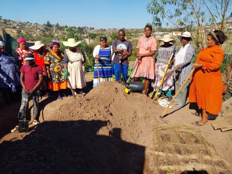 New group members are trained how to make a deep trench in a workshop.