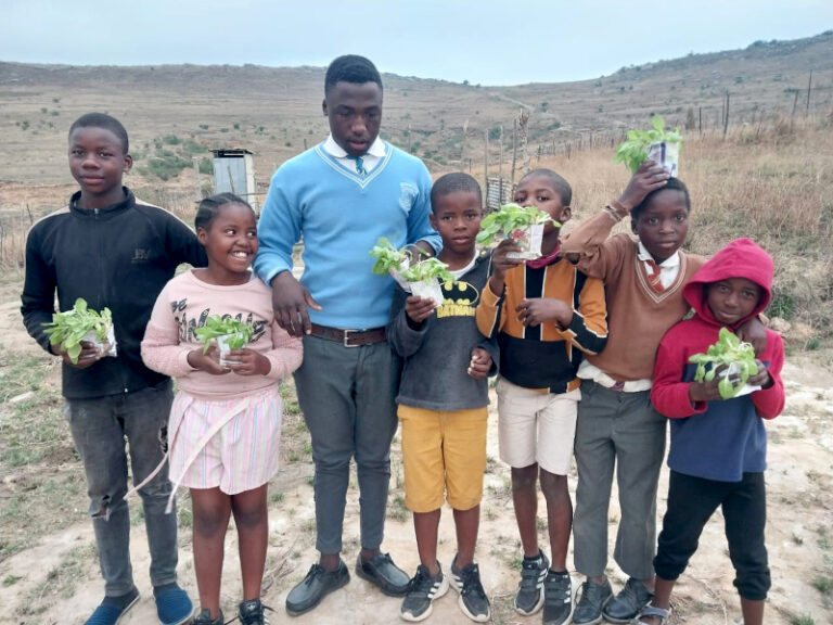 These Children from Phumeceleni zone at Emondlo area proudly carry seedlings they nurtured.